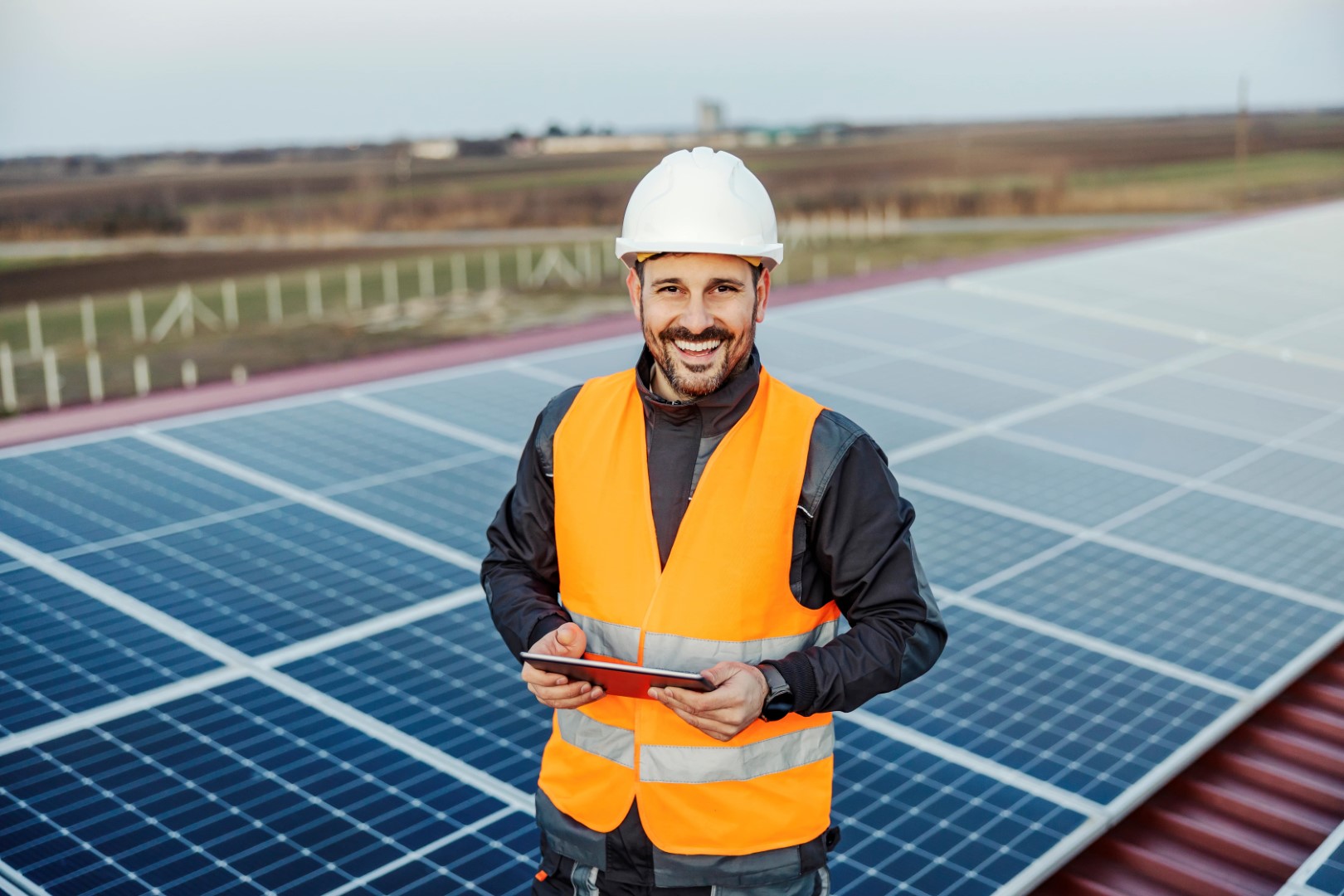 Safety professional with tablet at solar panel installation site
